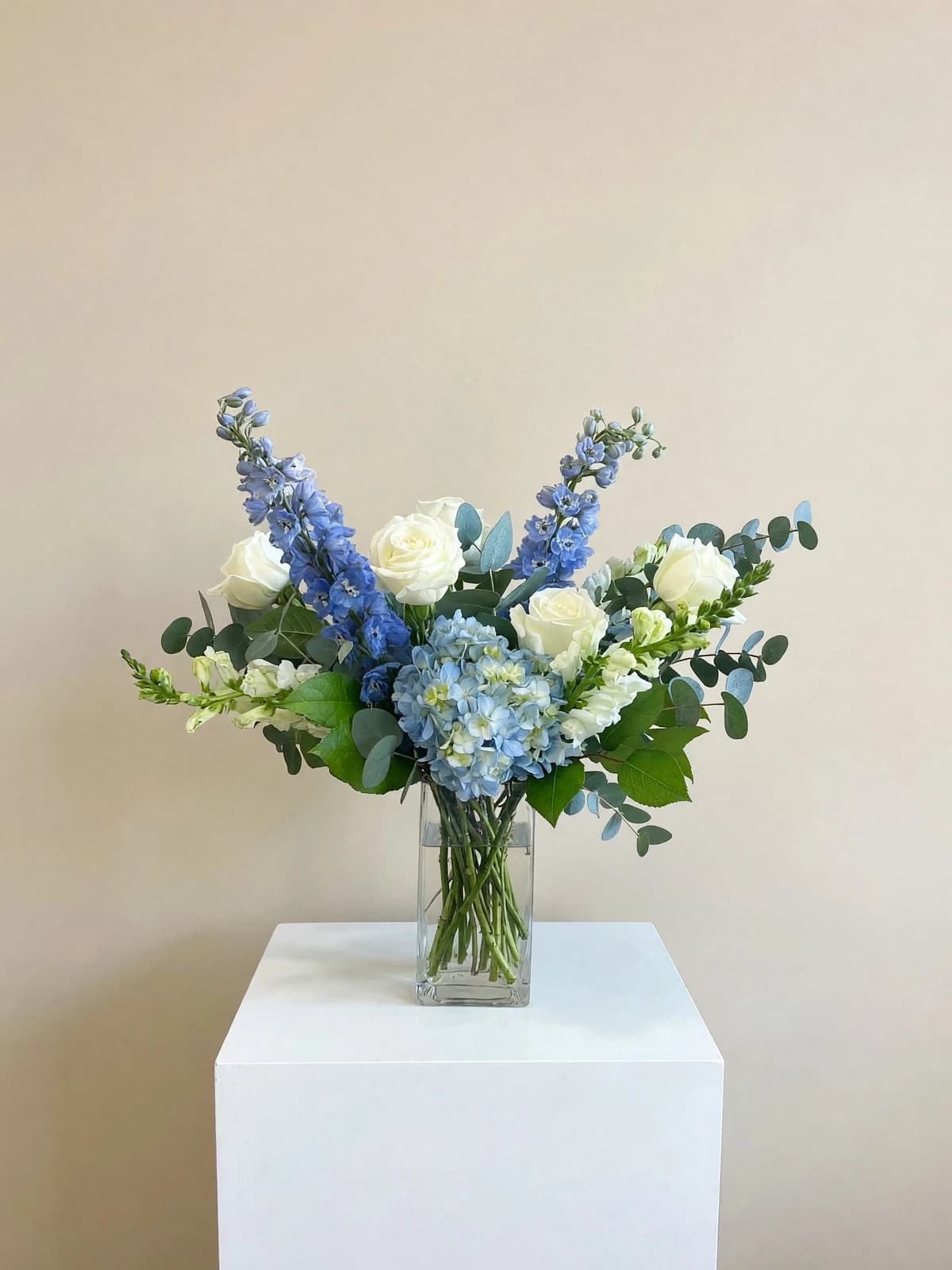 A crisp, elegant mix of blue and white blooms with lush greenery, for a calm, classic look. Bright and serene, it’s a lovely choice for birthdays, thank-yous, get-well wishes, or sympathy, and brings a sense of peace to any room.