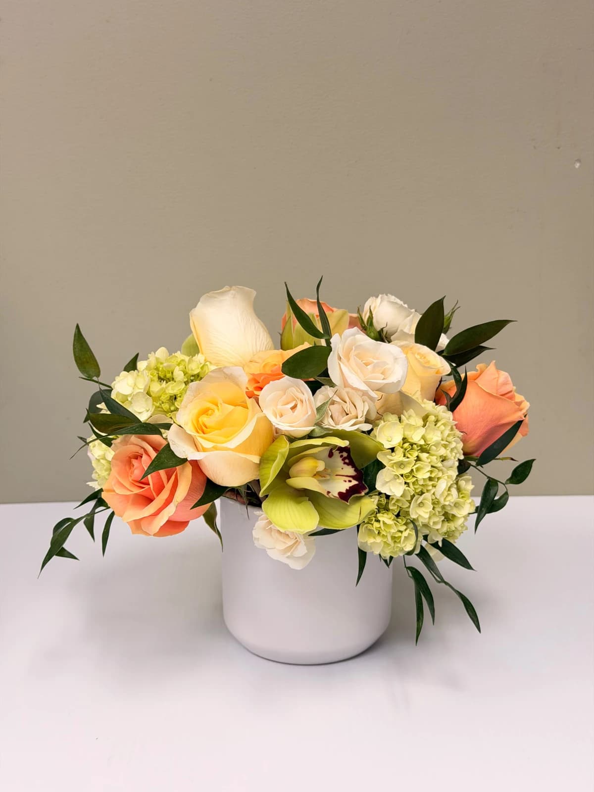 Soft roses and delicate blooms gathered in a refined, garden-style design. Presented in a clean ceramic vessel — understated, elegant, and perfect for any special occasion.