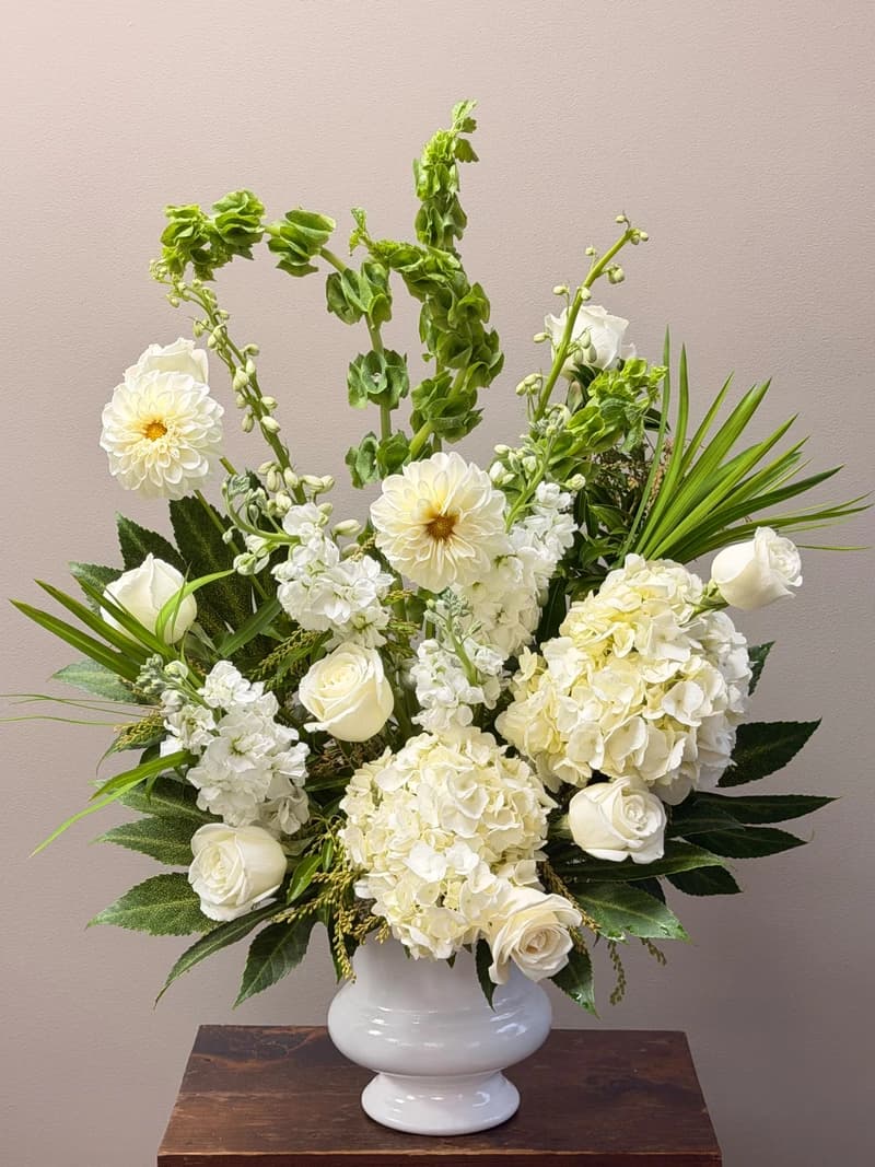 A graceful arrangement in soft shades of white, a peaceful tribute to honor a life.